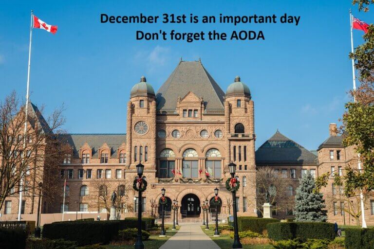 A picture of Queens Park. the Ontario Parliament Building with Christmas wreaths hung from the lamp posts with the caption that reads: December Thirty-first is an important day. Don't forget the AODA